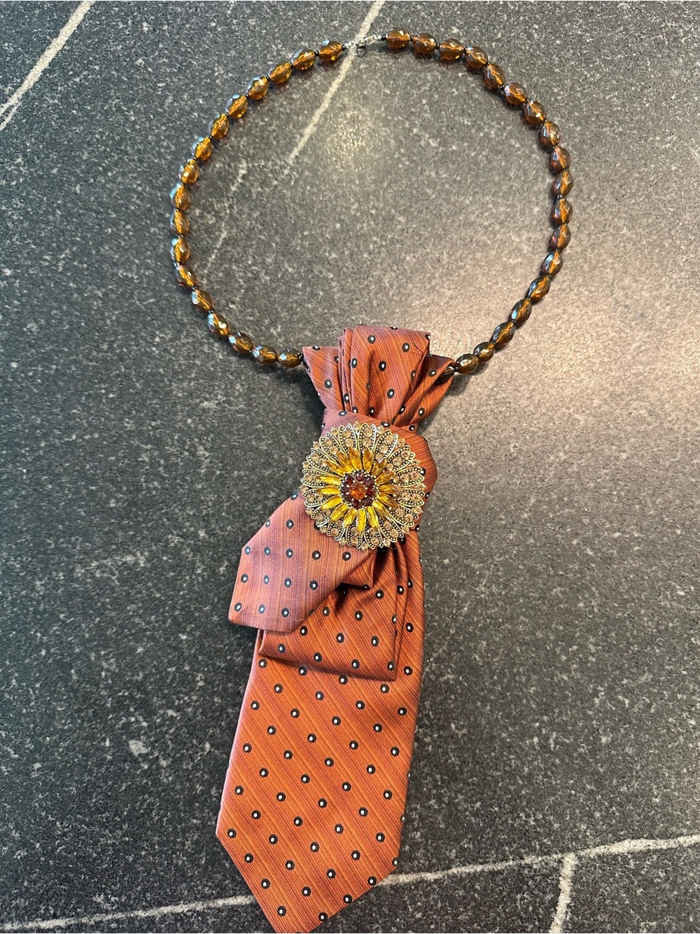 Murano Amber Bead Necklace with Rust Polka-Dot Tie and Gold Sunburst Brooch